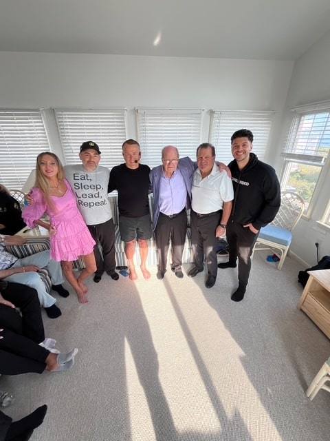 Group of people,legal team, gathering at a sunny indoor event.