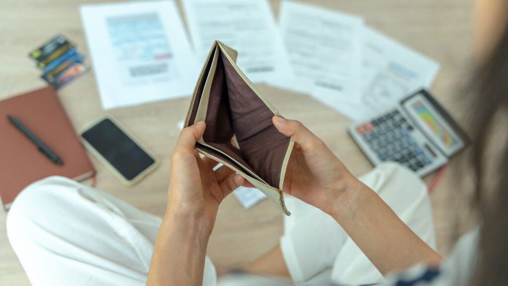 Empty wallet and financial papers illustrating tax challenges in Missouri.