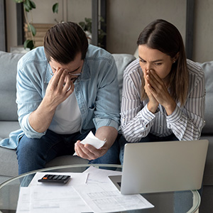 Here is the alt text of the image shared by the design team: Stressed Missouri business owners review financial documents